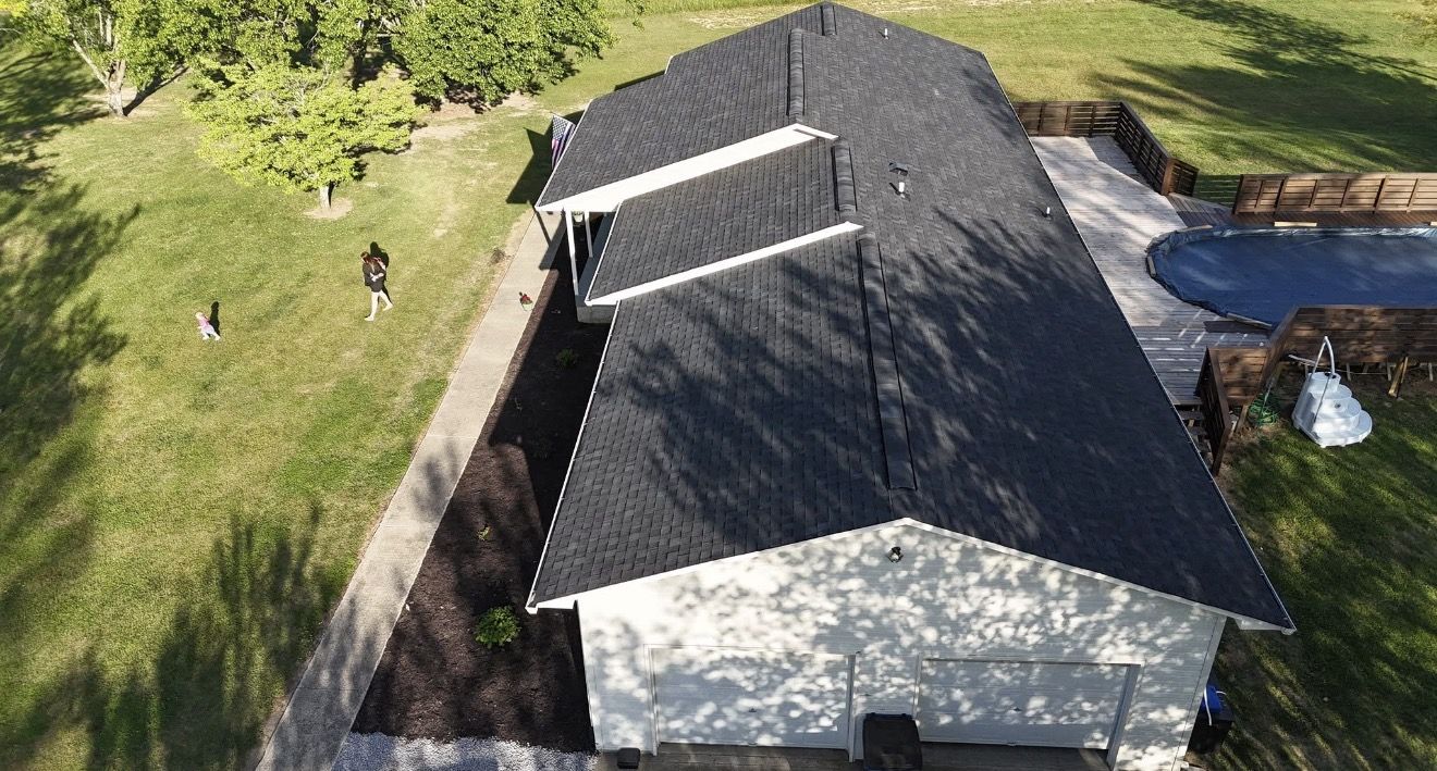 Finished shingle roof over an attached deck and pool area