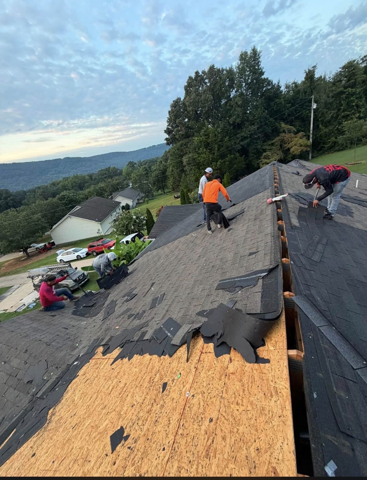 Roofer repairing a section of shingle roof
